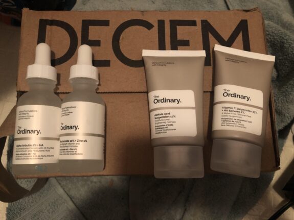 Azelaic Acid, Niacinamide, & Alpha Arbutin serum bottle.